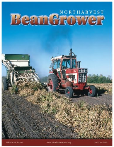 Red tractor harvesting beans on a field for Northarvest Bean Grower magazine cover.