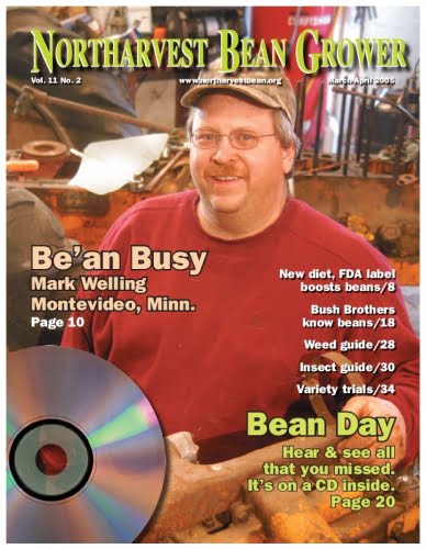 Man on 'Northarvest Bean Grower' magazine cover with CD, emphasizing agricultural content.
